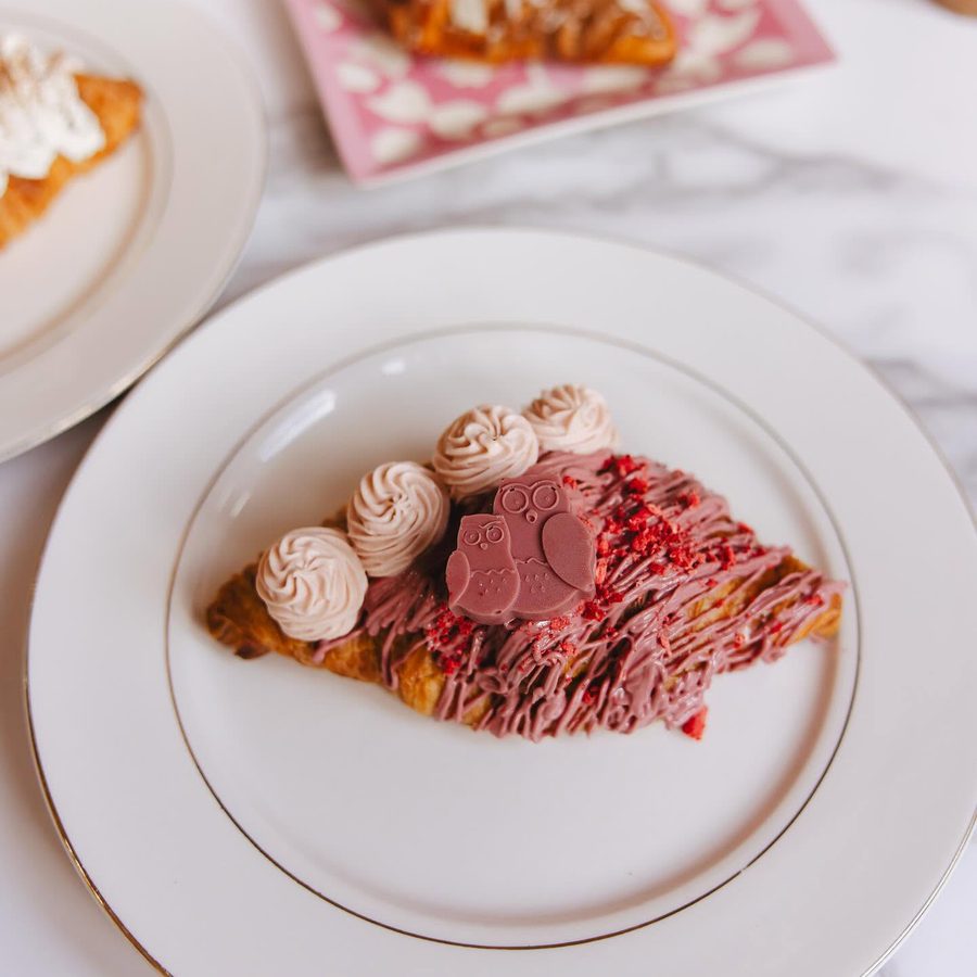 Ruby chocolate croissant with a small chocolate owl on top
